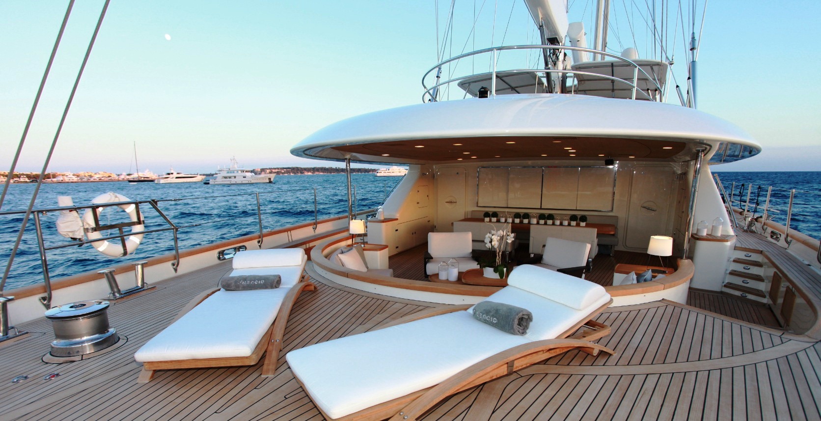 super yacht with sailboat on deck